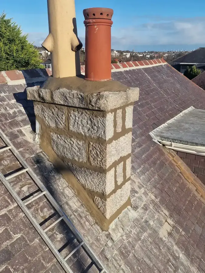 Another granite chimney stack with fresh pointing and flaunching around its pots
