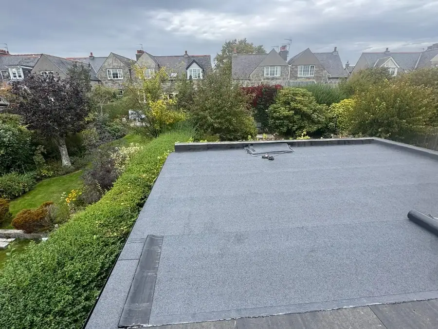 A finished flat roof with gardens and houses behind