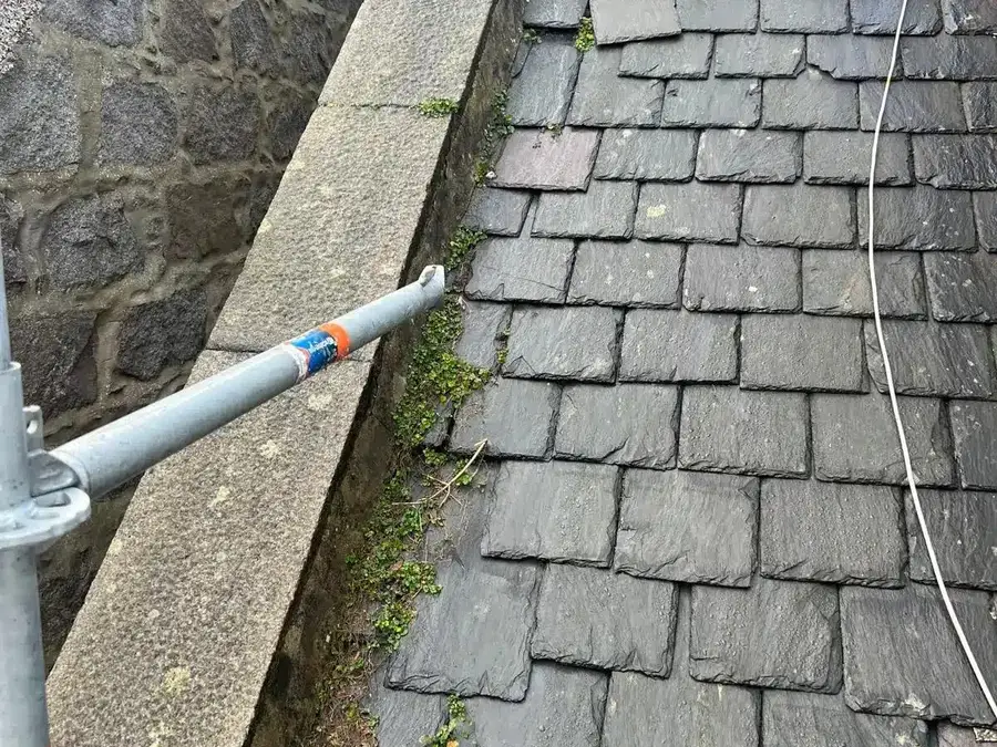 Slates along a granite skew with moss in the joints