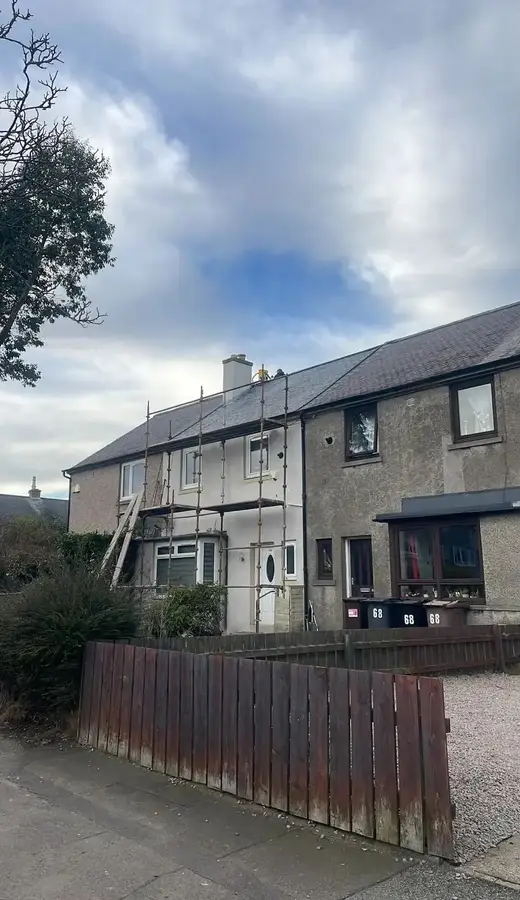 The terraced house with scaffold up, seen from the street