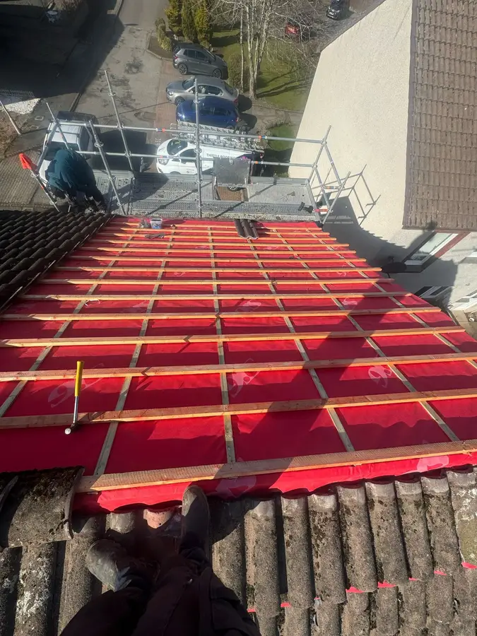 Red breathable membrane and new battens on a stripped roof