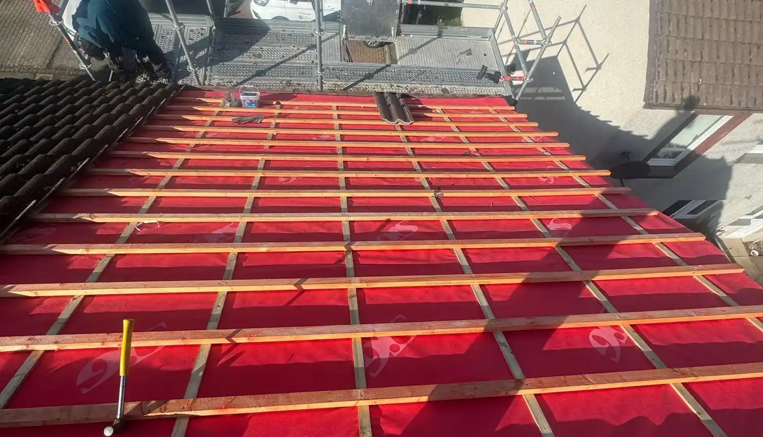 Red breathable membrane and new battens on a stripped roof